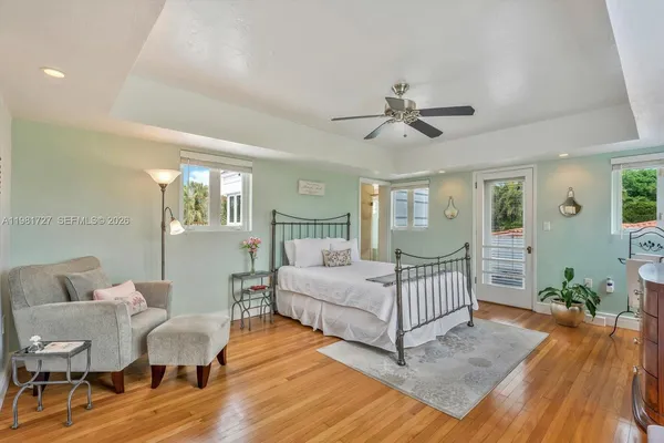 a spacious bedroom with a bed and dresser