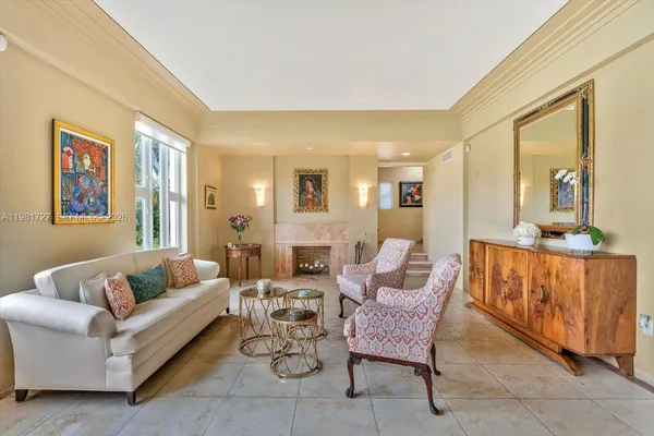 a living room with furniture and a book shelf