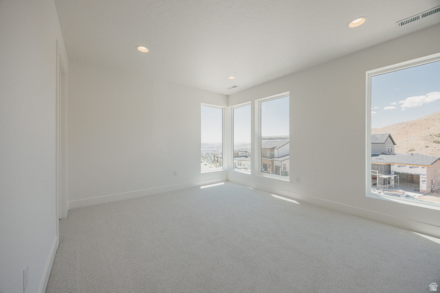 5902 Canyon Rim Road, Unit 620 Lehi, UT 84048 - Photo 54 of 78 Bright interior room featuring multiple large windows, recessed ceiling lighting, a light-toned carpet, and white baseboards