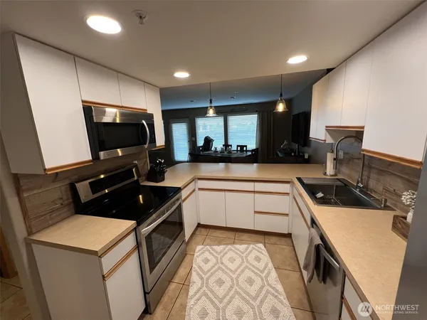a kitchen that has a sink and a stove in it