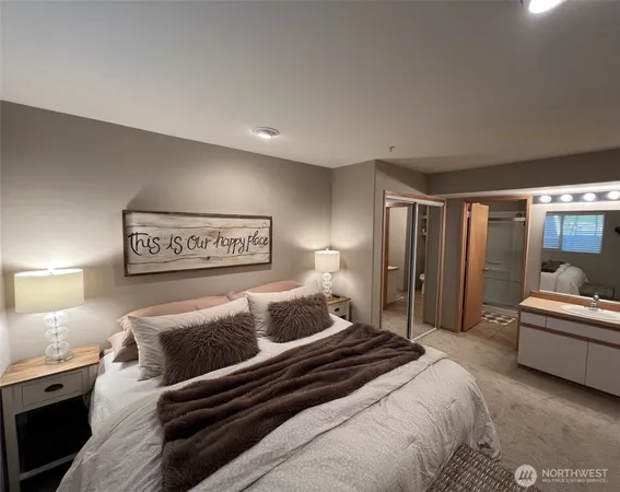 a bedroom with a bed and a large window