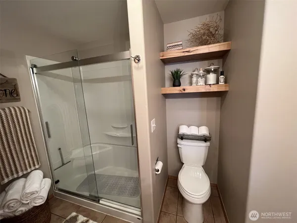 a bathroom with a toilet and a shower