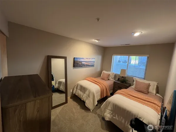 a bedroom with two beds and painted walls