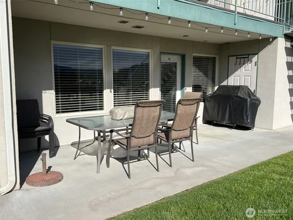 a view of a patio with table and chairs and potted plants
