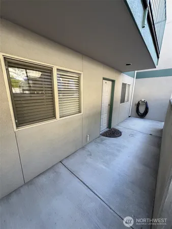 a view of a livingroom with an empty space and a window