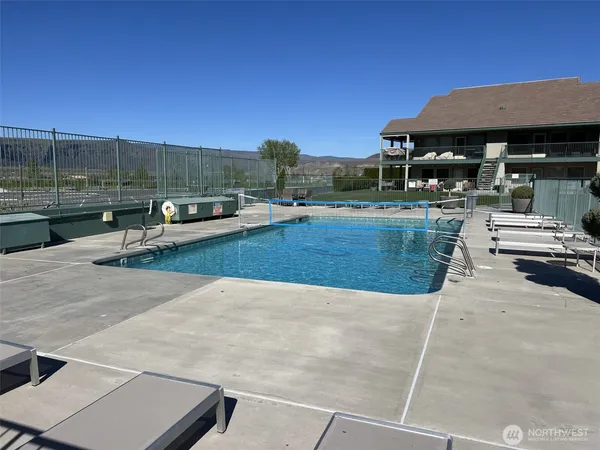 a view of a patio with couches and pool