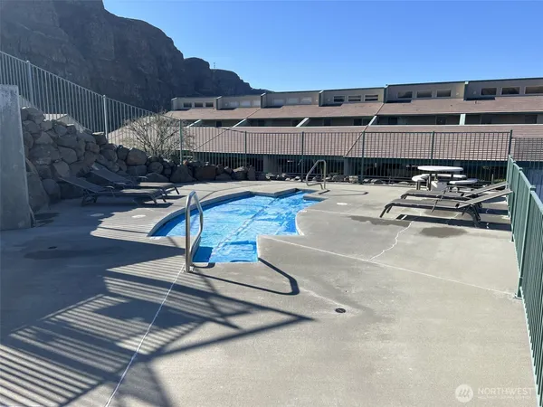 a view of a swimming pool with a lounge chair