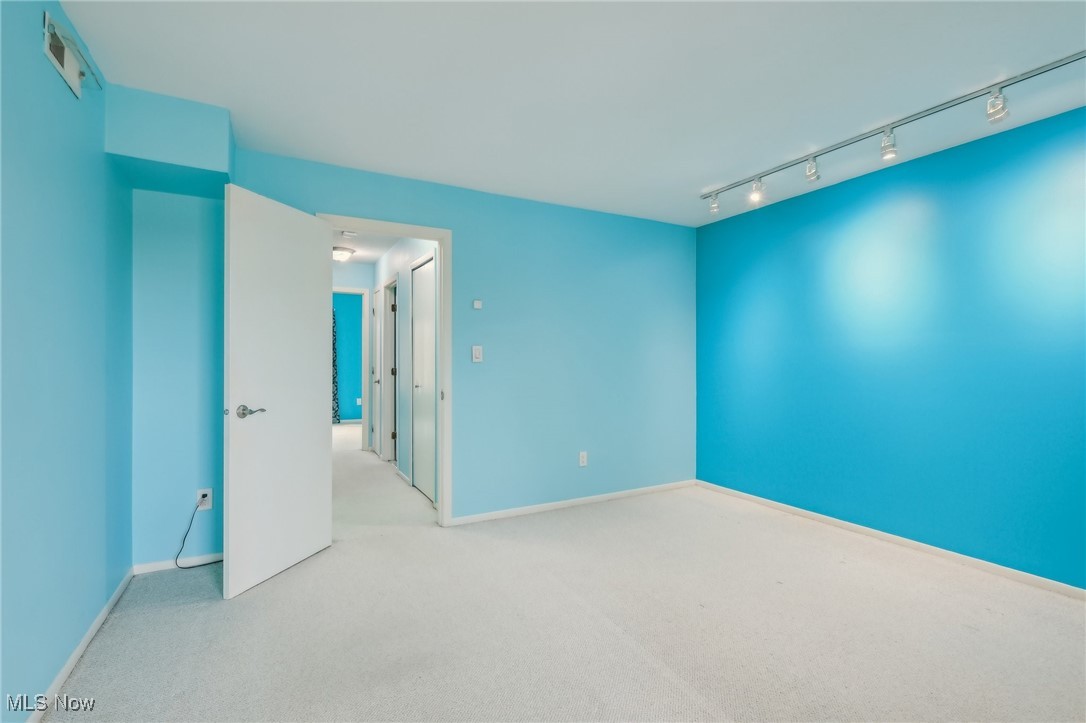 3484 Mayfield Road, Unit 3426 Cleveland Heights, OH 44118 - Photo 24 of 33 Unfurnished room with baseboards, visible vents, track lighting, and carpet