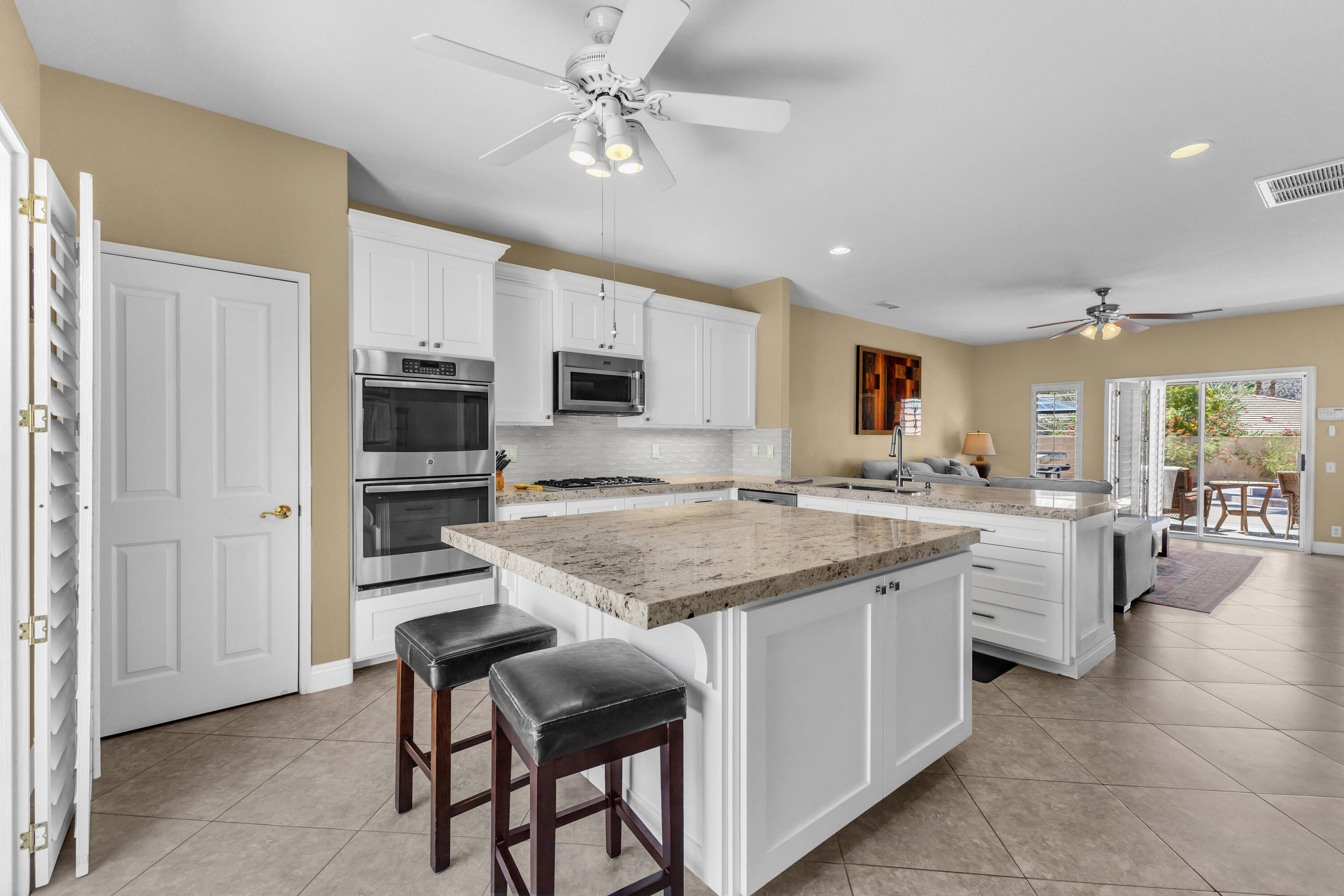 47845 Vía Opera La Quinta, CA 92253 - Photo 13 of 47 a kitchen with white cabinets appliances and chandelier