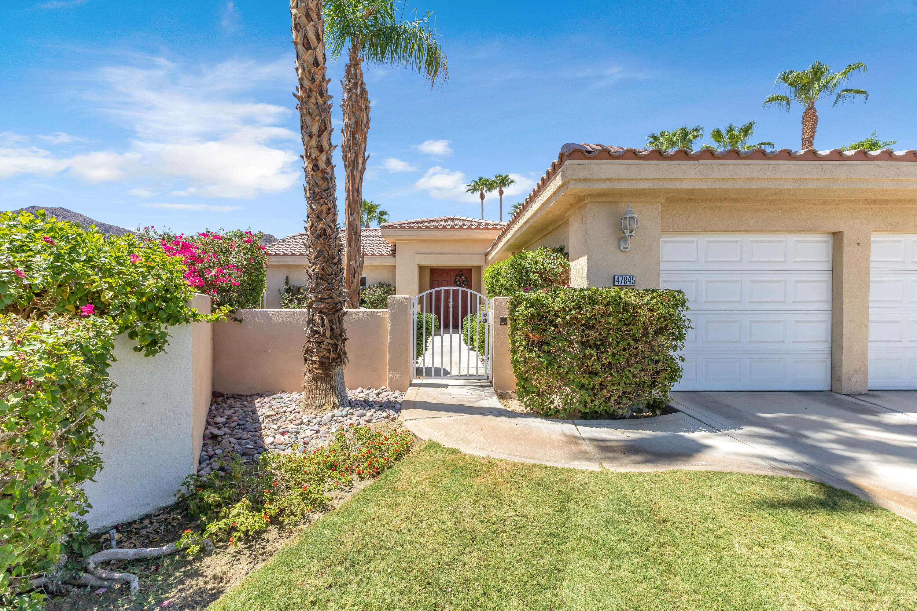 47845 Vía Opera La Quinta, CA 92253 - Photo 5 of 47 a front view of a house with a yard
