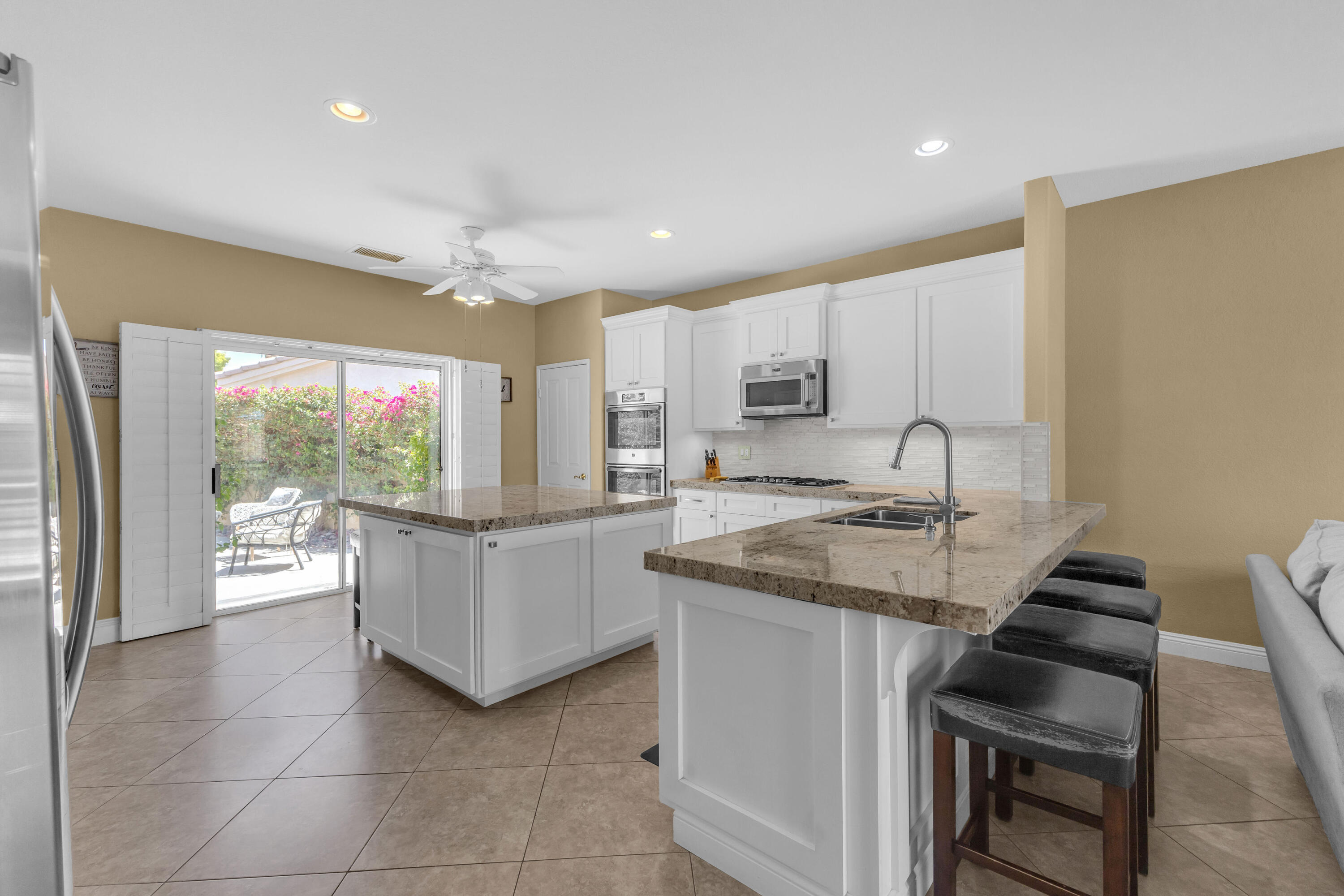 47845 Vía Opera La Quinta, CA 92253 - Photo 10 of 47 a kitchen with a sink stove and cabinets