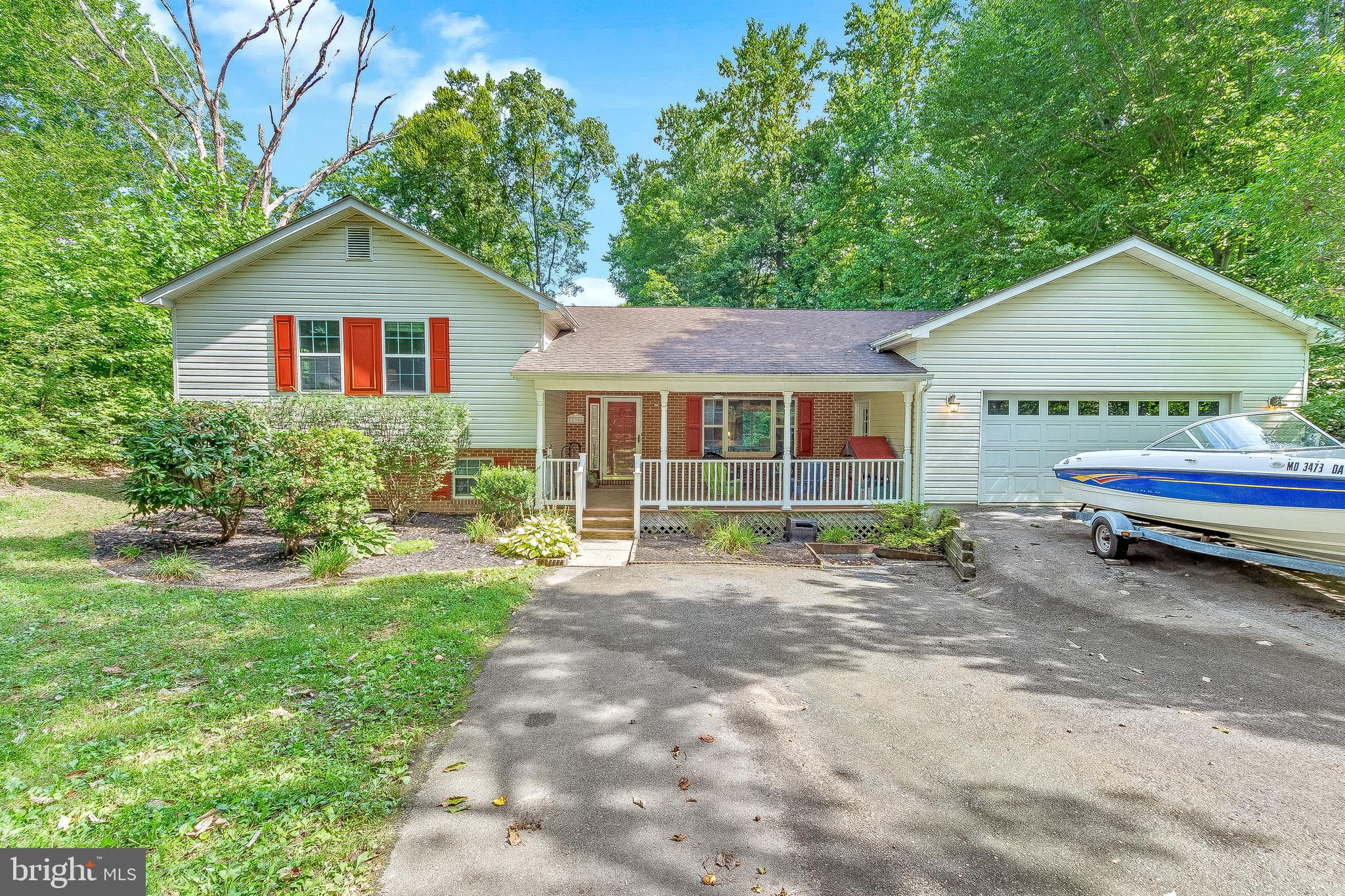 11356 Redlands Road Lusby, MD 20657 - Photo 1 of 36 a front view of a house with a yard and porch