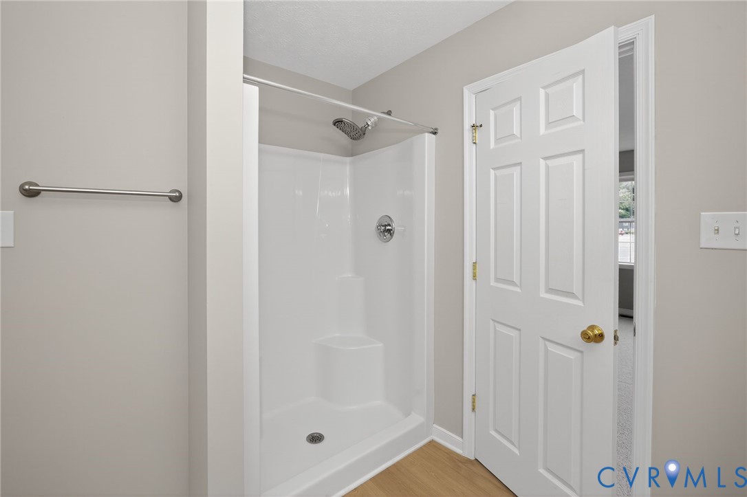 1827 Clarkson Road Richmond, VA 23224 - Photo 14 of 24 a bathroom with a glass shower door
