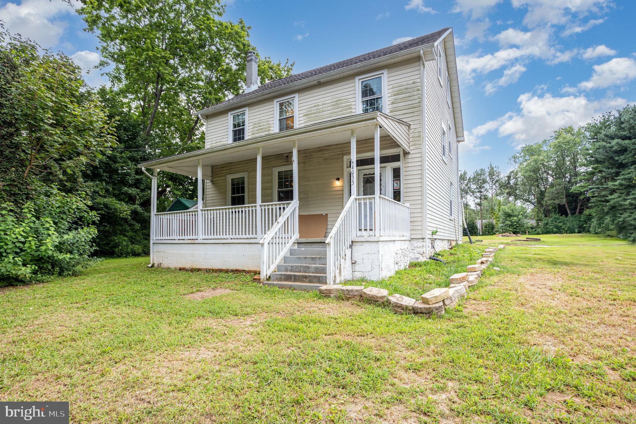 a view of house with backyard and garden