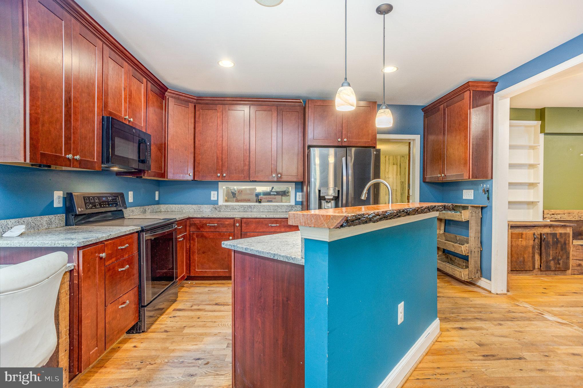 4033 Conowingo Road Darlington, MD 21034 - Photo 8 of 42 a kitchen with stainless steel appliances granite countertop wooden cabinets a stove top oven a sink and dishwasher