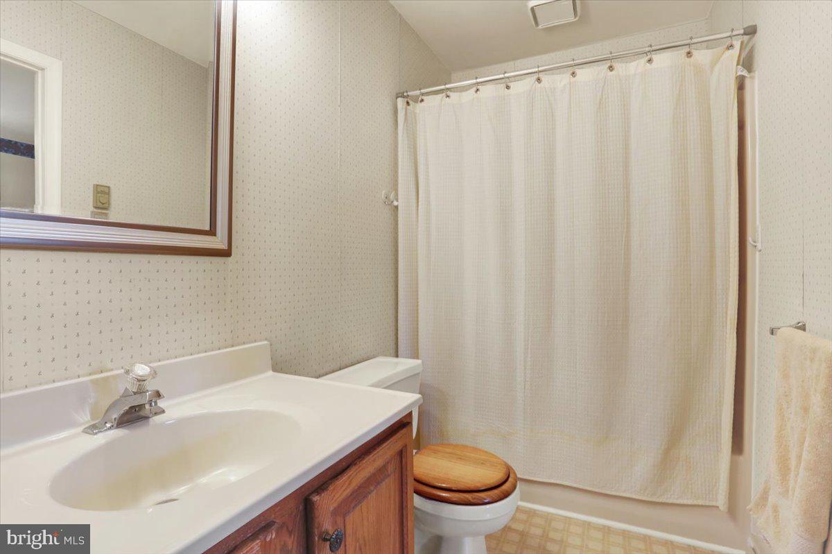 2127 Fairview Avenue Reading, PA 19606 - Photo 18 of 28 a bathroom with a sink a toilet and a mirror