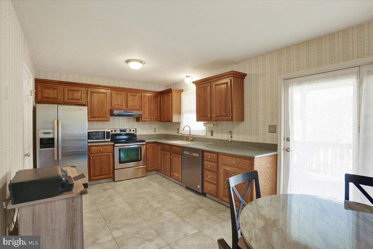 2127 Fairview Avenue Reading, PA 19606 - Photo 7 of 28 a kitchen with stainless steel appliances granite countertop a refrigerator and a stove top oven