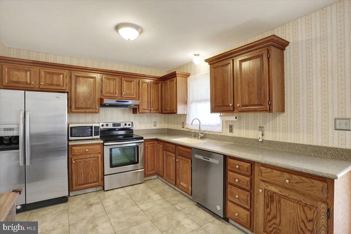 2127 Fairview Avenue Reading, PA 19606 - Photo 8 of 28 a kitchen with stainless steel appliances granite countertop a sink stove refrigerator and cabinets