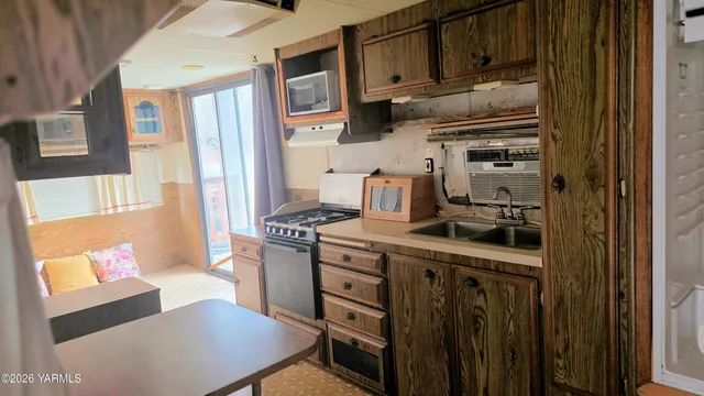 a kitchen with stainless steel appliances a stove a refrigerator and a cabinets