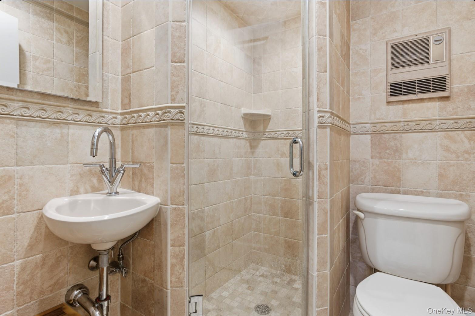 253 Dune Road, Unit 49 Westhampton Beach, NY 11978 - Photo 18 of 31 a bathroom with a sink a toilet and shower