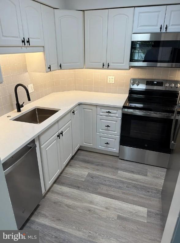 37 East Montgomery Avenue, Unit 2 Ardmore, PA 19003 - Photo 5 of 11 a kitchen with granite countertop a stove and a sink