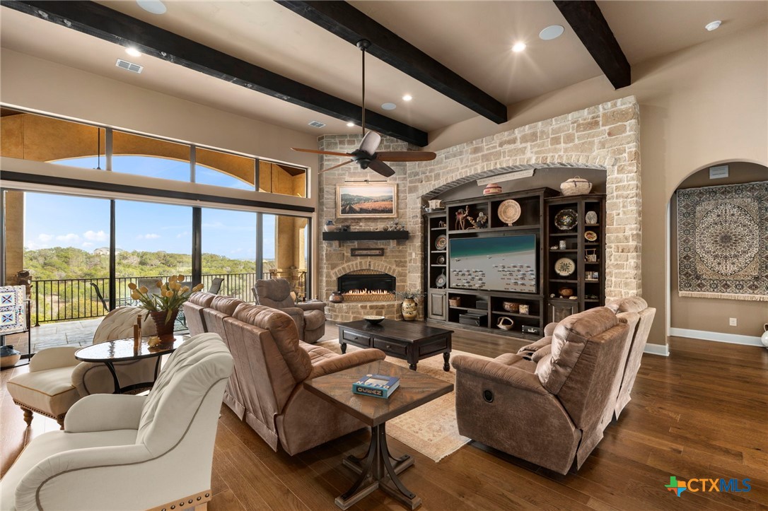 1039 Bluewater Place Spring Branch, TX 78070 - Photo 13 of 48 a living room with fireplace furniture and a large window