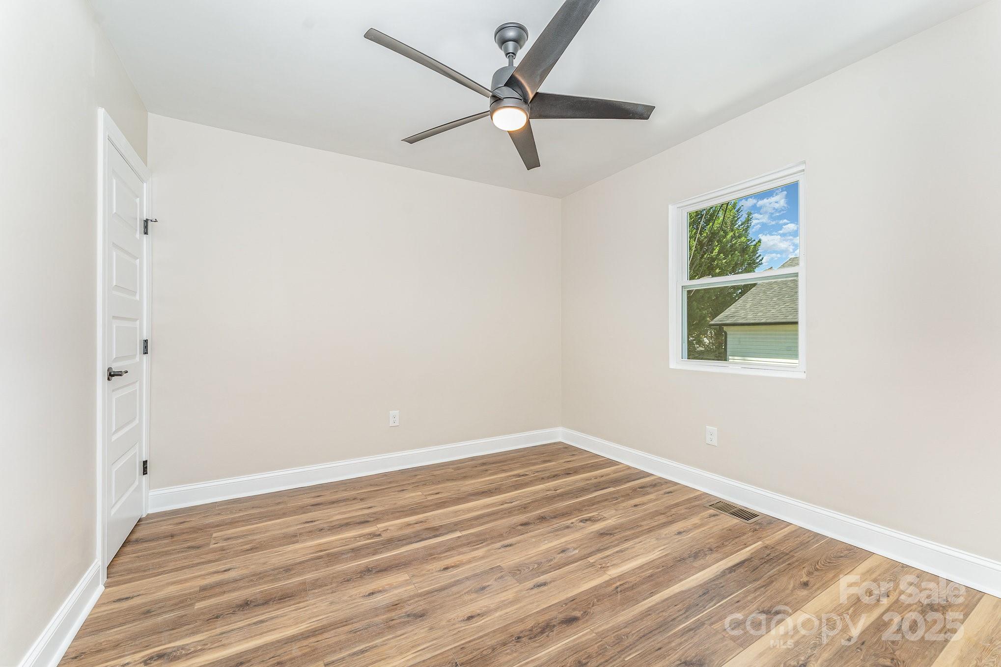 112 Circle Drive Salisbury, NC 28144 - Photo 26 of 34 an empty room with a window and a ceiling fan