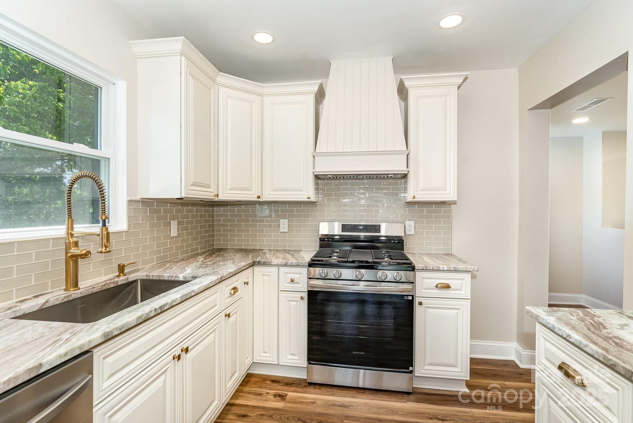 112 Circle Drive Salisbury, NC 28144 - Photo 5 of 34 a kitchen with stainless steel appliances granite countertop a stove a sink and white cabinets