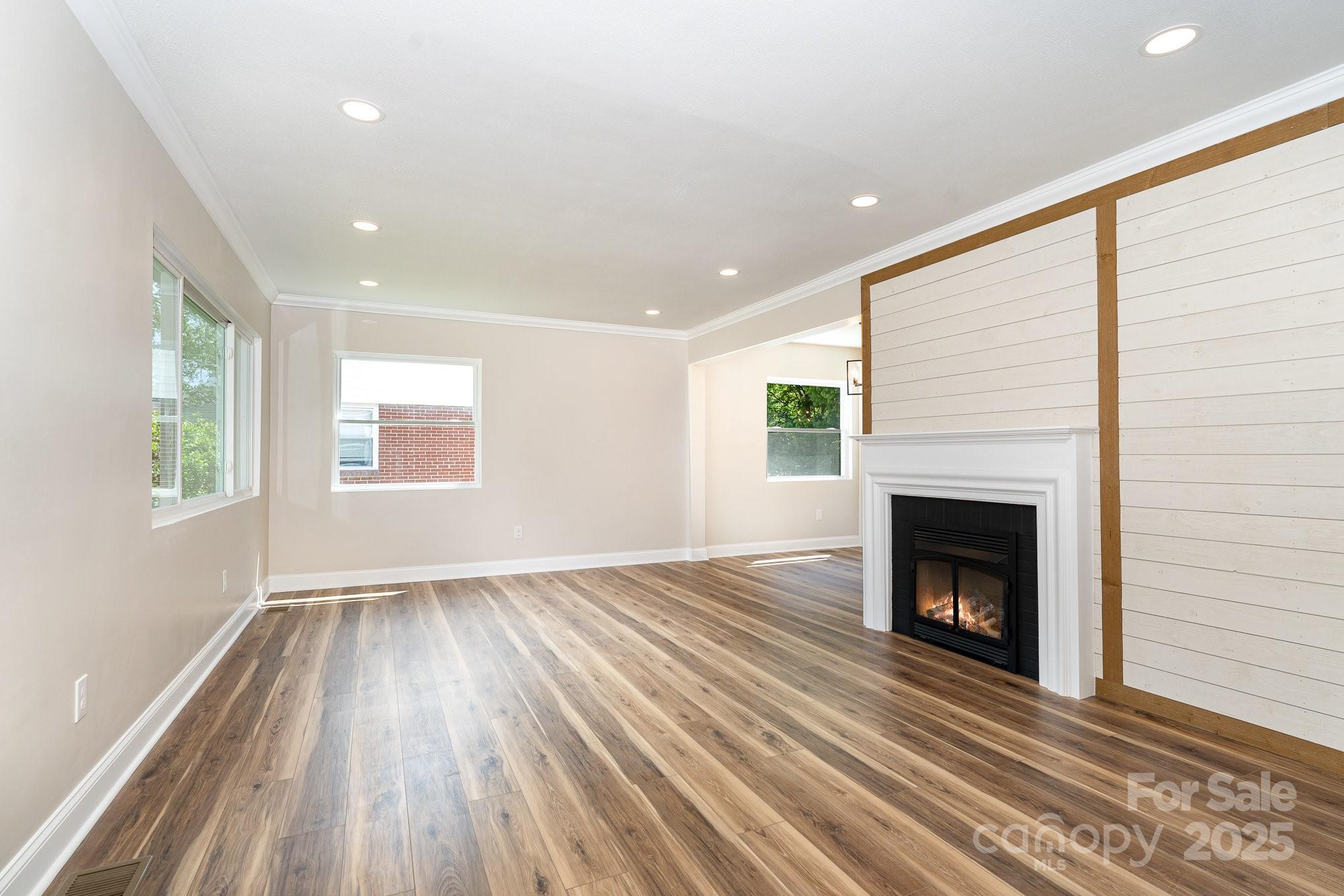 112 Circle Drive Salisbury, NC 28144 - Photo 6 of 34 a view of an empty room with wooden floor fireplace and a window