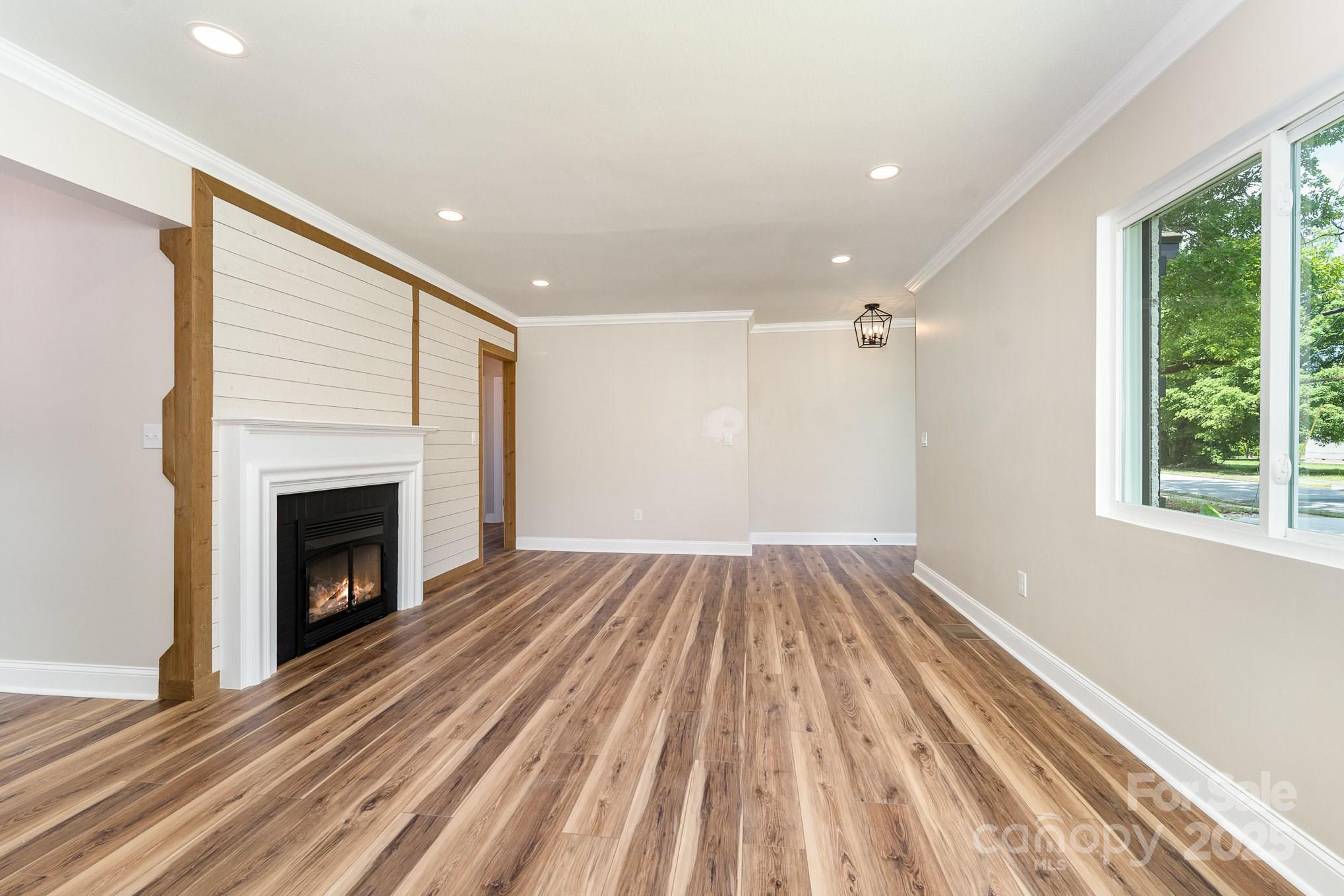 112 Circle Drive Salisbury, NC 28144 - Photo 7 of 34 a view of empty room with wooden floor and fireplace