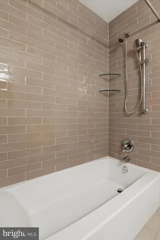 a bathroom with a bathtub and shower