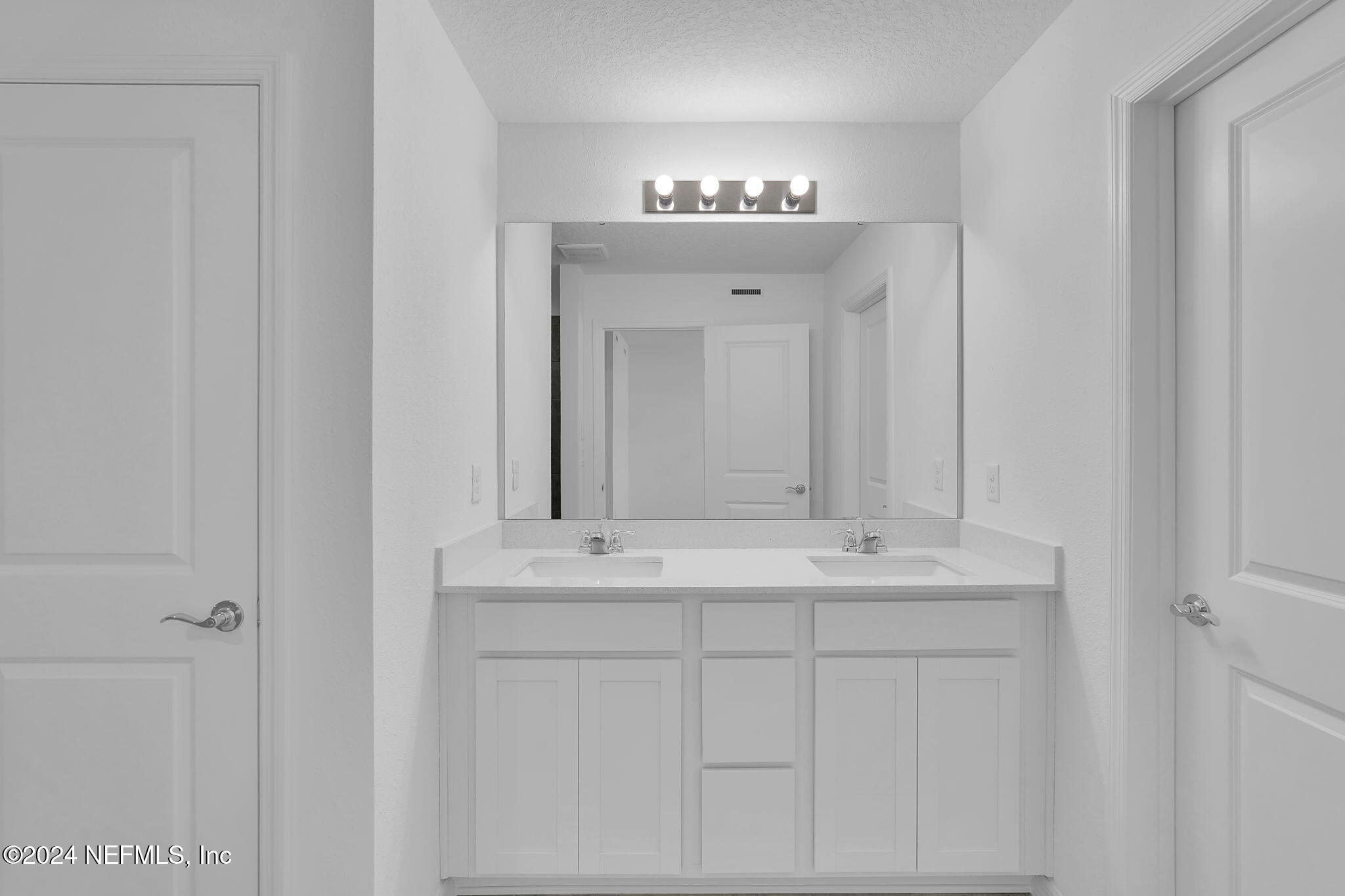 10121 Deep Pine Jacksonville, FL 32221 - Photo 17 of 24 a bathroom with a sink and a mirror