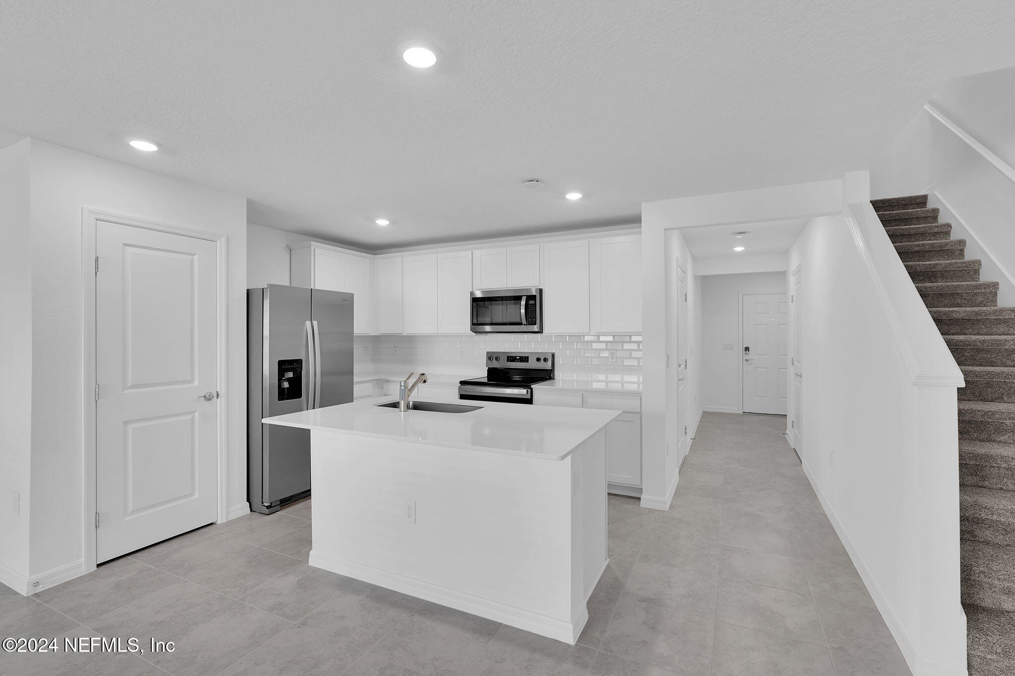 10121 Deep Pine Jacksonville, FL 32221 - Photo 6 of 24 a kitchen with stainless steel appliances a refrigerator stove and white cabinets
