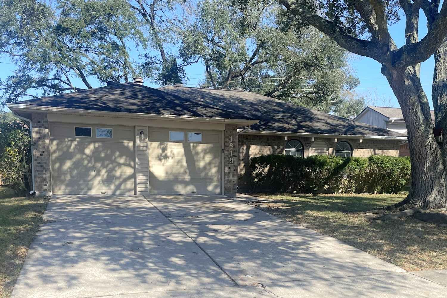 a view of a house with a tree in a yard