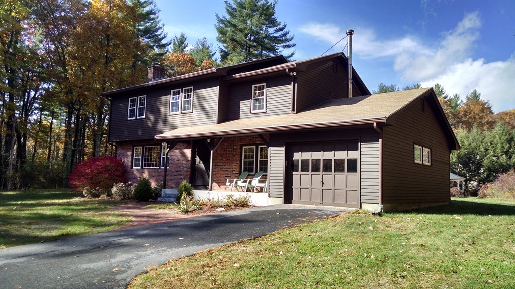 151 Hudson Road Stow, MA 01775 - Photo 1 of 17 front view of a house with a yard