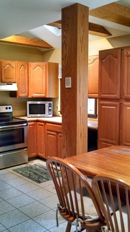 151 Hudson Road Stow, MA 01775 - Photo 2 of 17 a kitchen with stainless steel appliances kitchen island granite countertop a refrigerator stove top oven and sink