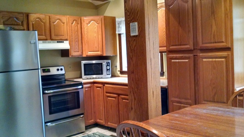 151 Hudson Road Stow, MA 01775 - Photo 3 of 17 a bedroom with a bed and a refrigerator