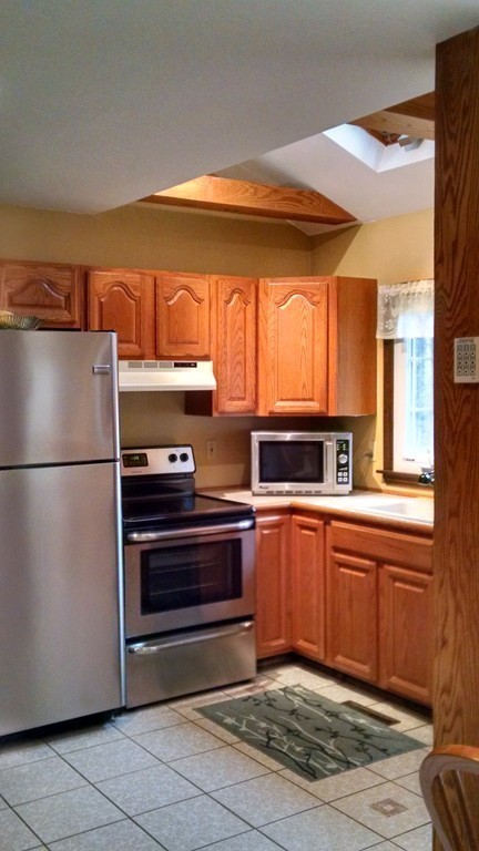 151 Hudson Road Stow, MA 01775 - Photo 4 of 17 a kitchen with a refrigerator and a sink