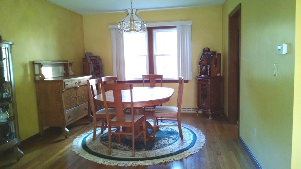 151 Hudson Road Stow, MA 01775 - Photo 7 of 17 a dining room with furniture a chandelier and wooden floor