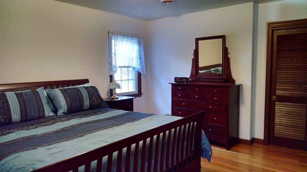 151 Hudson Road Stow, MA 01775 - Photo 10 of 17 a bedroom with a bed and wooden floor
