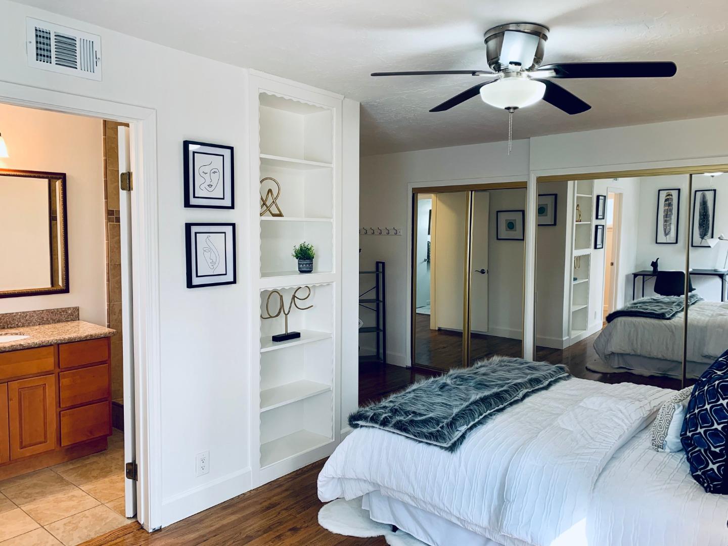 2432 Rinconada Drive San Jose, CA 95125 - Photo 17 of 33 a bedroom with a large bed and a chandelier