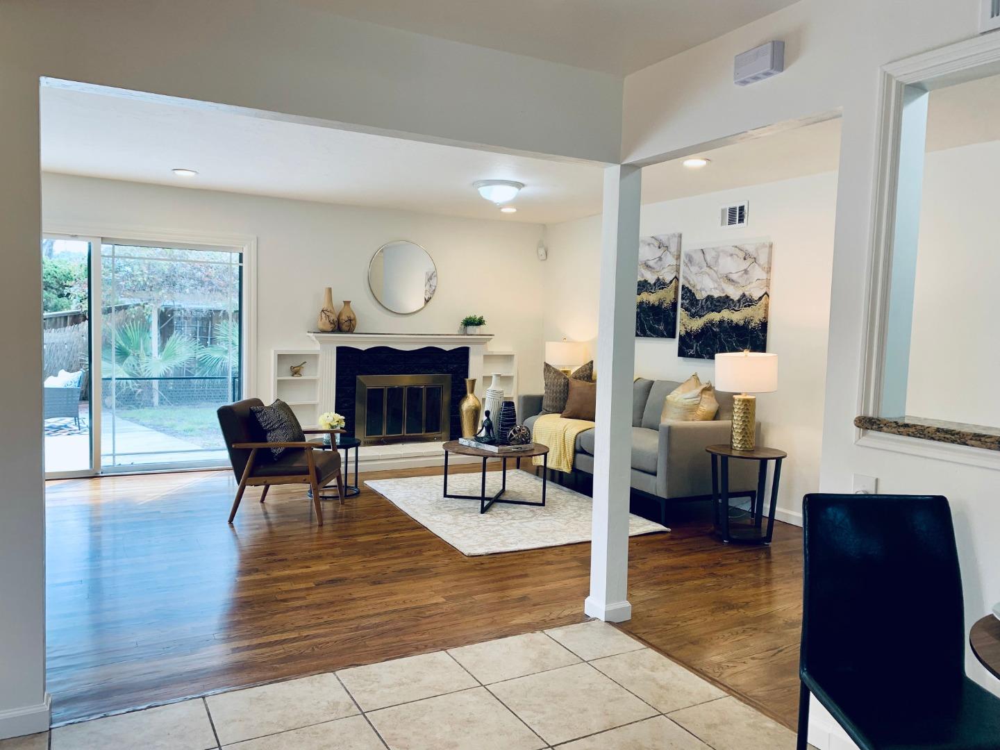 2432 Rinconada Drive San Jose, CA 95125 - Photo 6 of 33 a living room with furniture a fireplace a rug and a large window