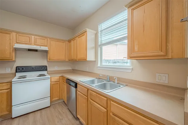 a kitchen with a sink stove and cabinets