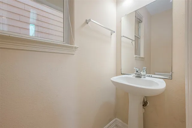 a bathroom with a sink a mirror and a bathtub