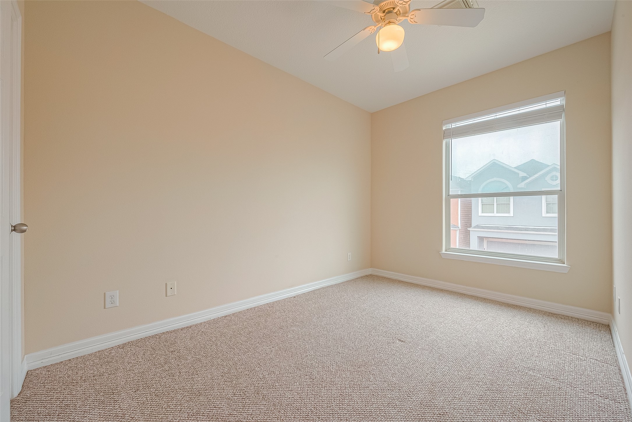 10355 Panther Point Drive Houston, TX 77099 - Photo 34 of 44 This is a bright, cozy room with neutral walls and carpet flooring. It features a large window with a view, allowing plenty of natural light. A ceiling fan adds comfort to the space.