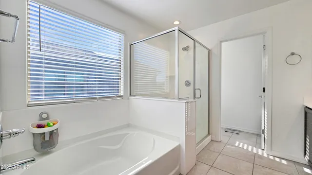 a bedroom with a bed and a flat tv screen on dresser