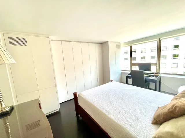 a bedroom with a bed and a table in it