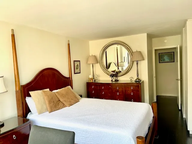 a bedroom with a bed and a dresser