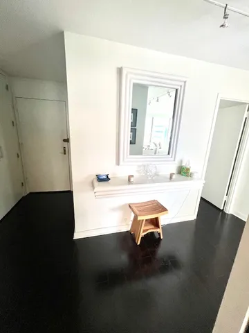 a room with a table chairs and a wooden floor