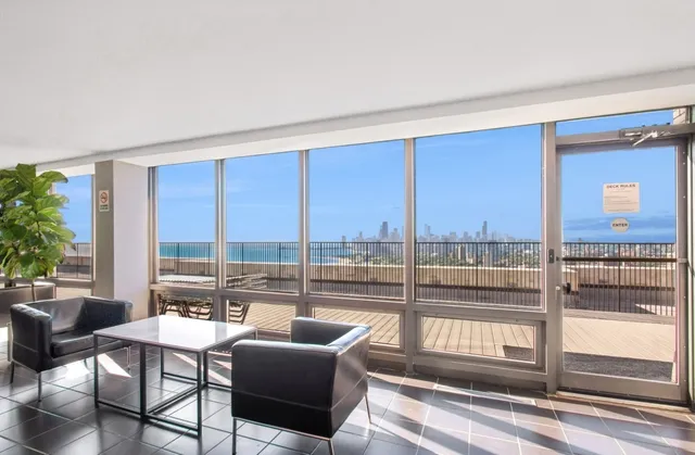 a living room with furniture and a floor to ceiling window